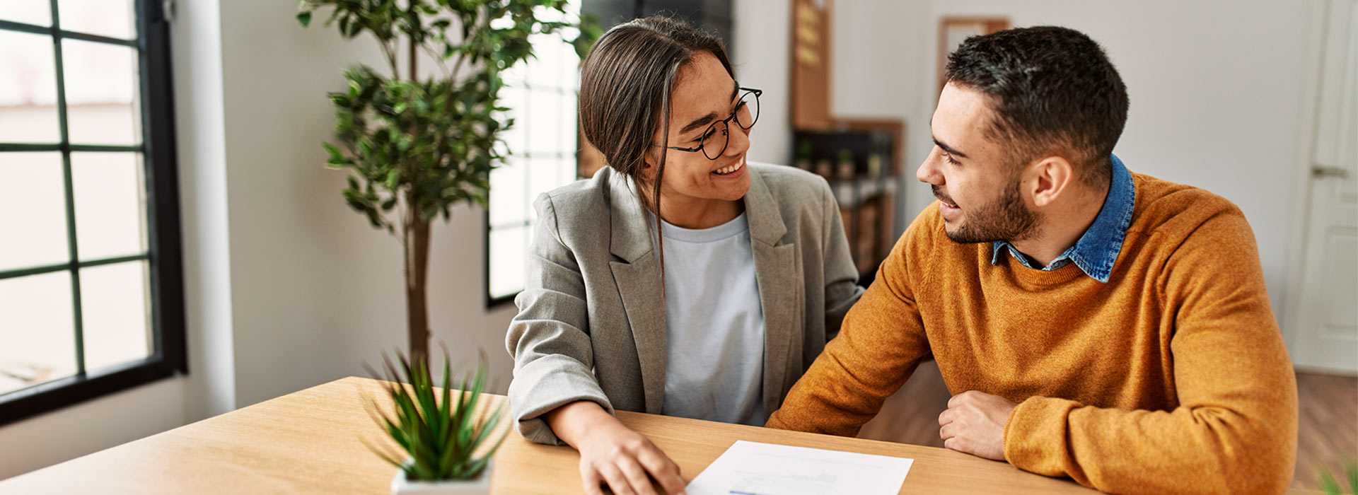 young couple happily filling out paperwork